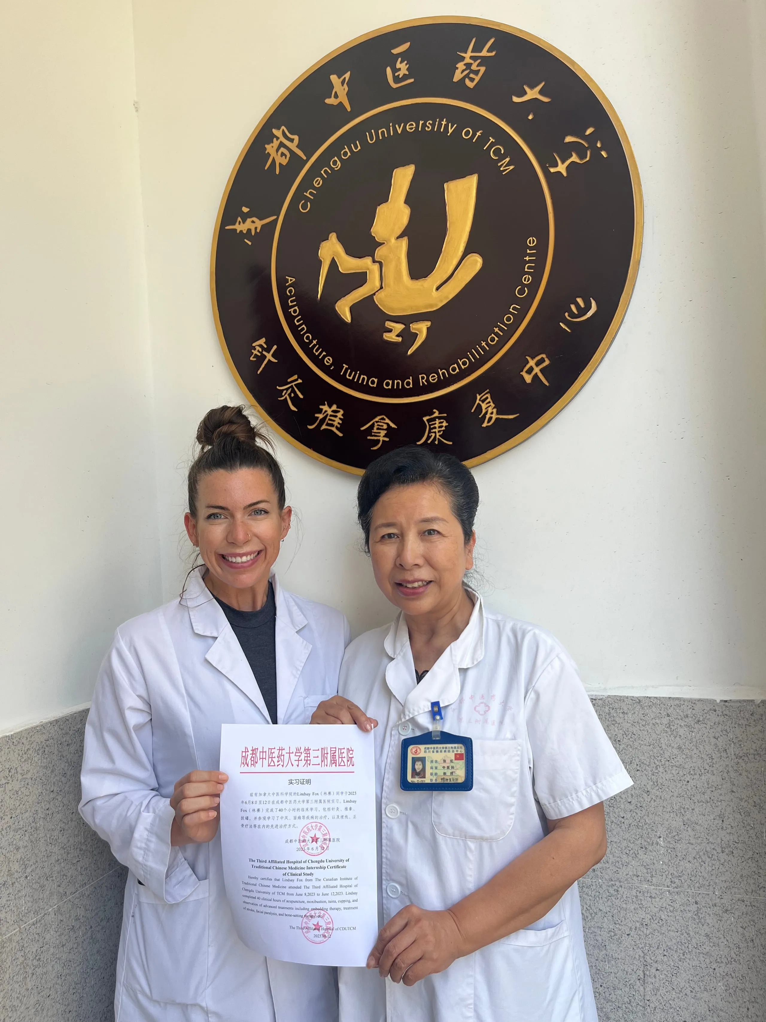 Dr. Lindsay Fox receiving her clinical internship certificate at Chengdu University of TCM