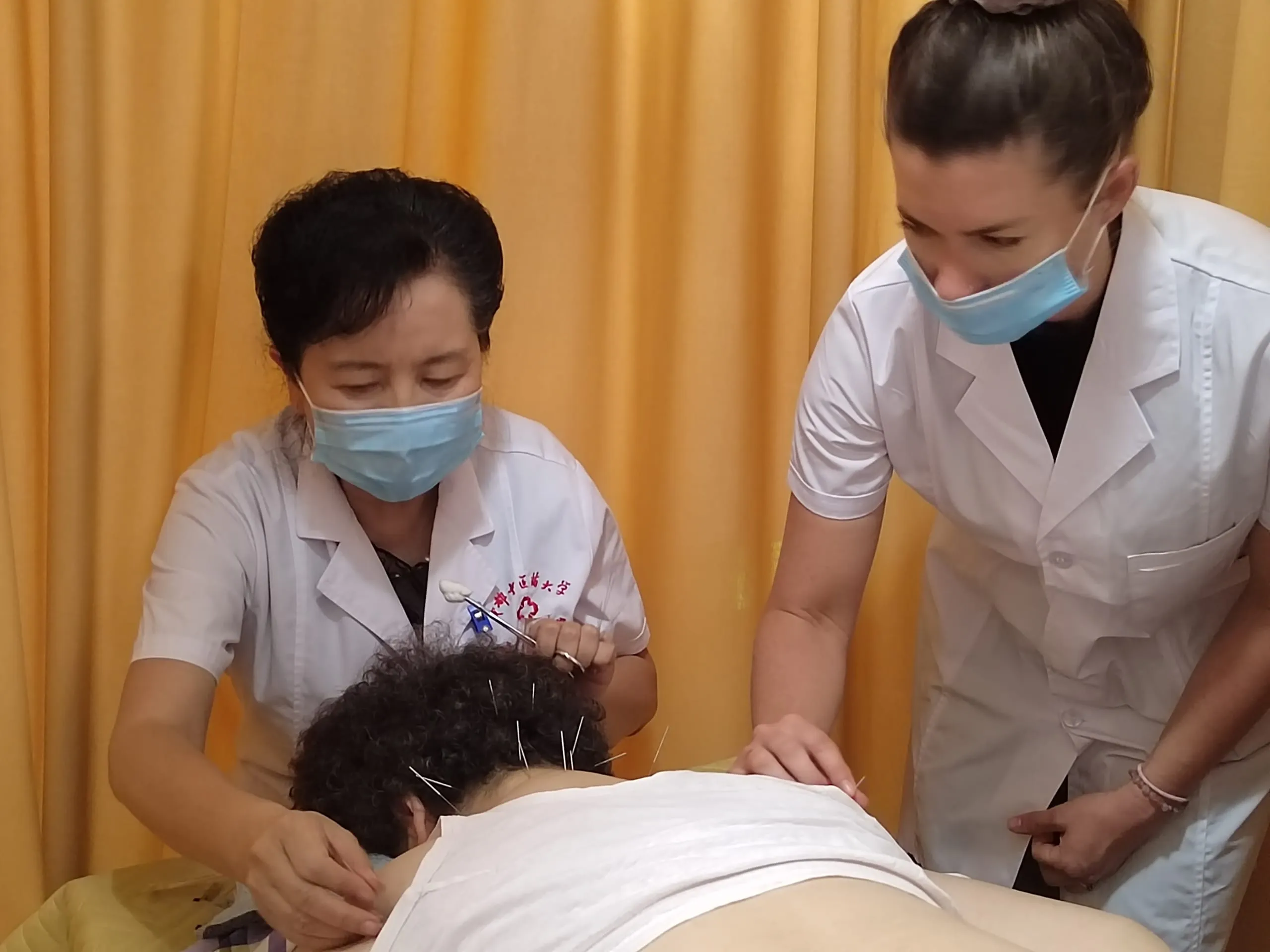 Dr. Lindsay Fox performing acupuncture during her hospital internship in China